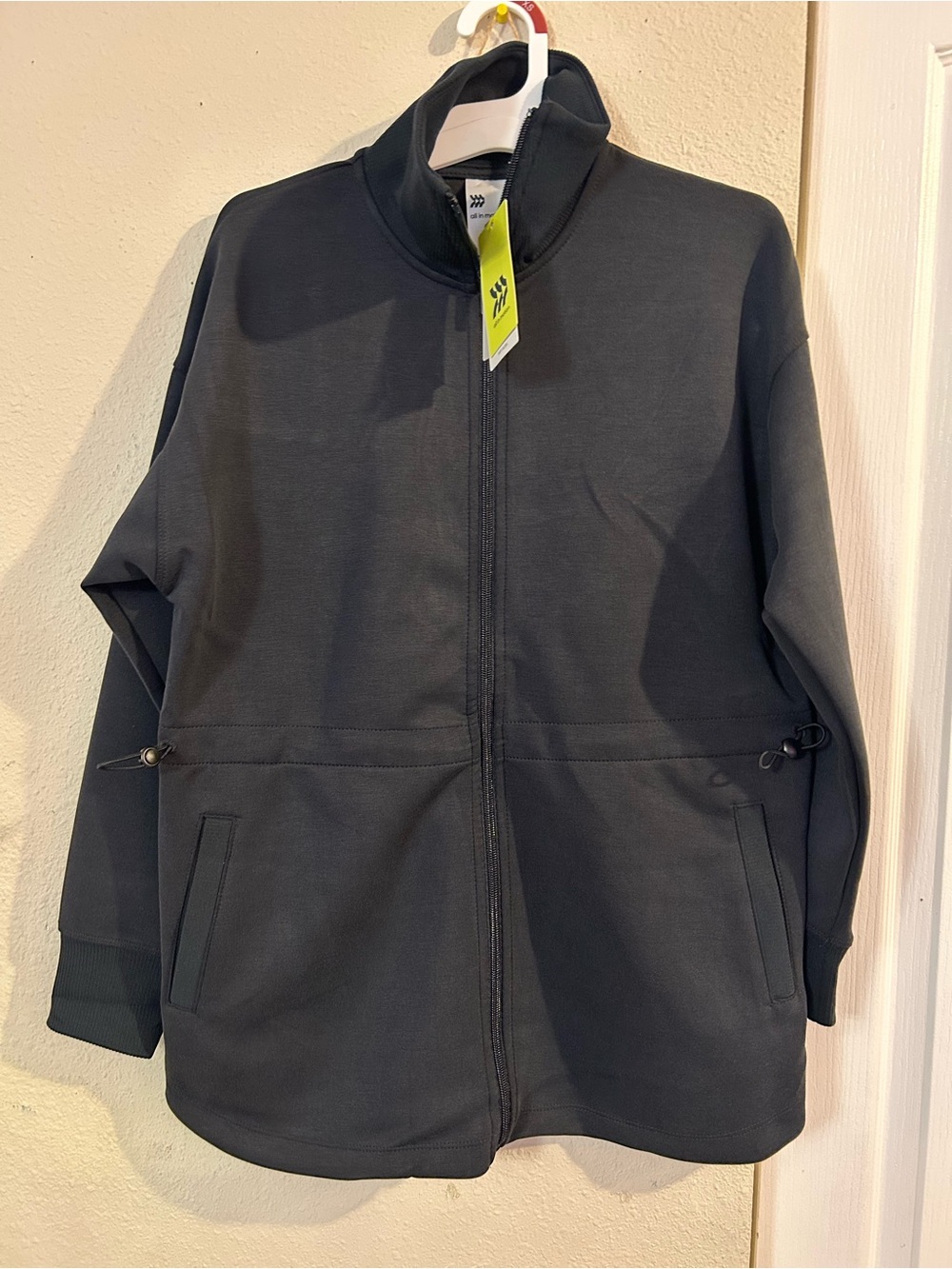 Women’s Black Full-Zip Jacket with Stand Collar, adjustable waist toggle.
